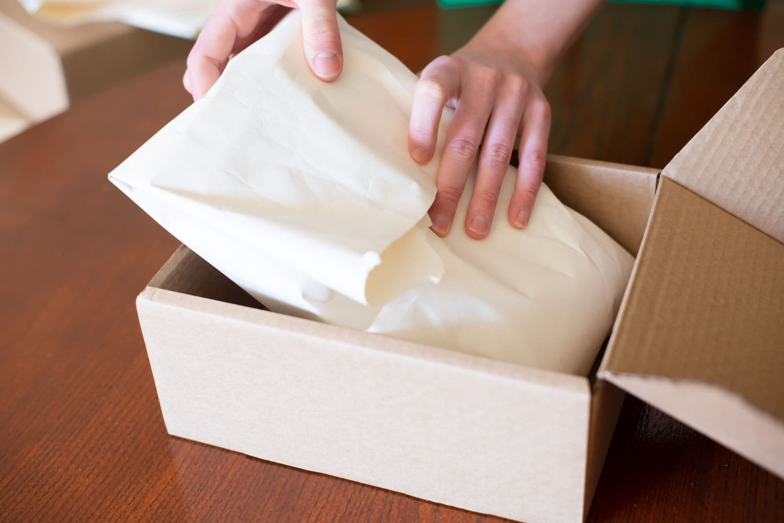 Shopify store owner packing an order